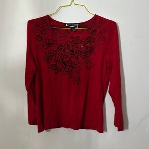 Very pretty red light sweater with floral designs. By Karen Scott, size is Large